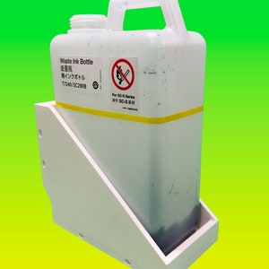 May include: A white plastic waste ink bottle with a handle, held in a white plastic holder. The bottle has a yellow stripe and text that reads "Waste Ink Bottle" in multiple languages. A no-smoking symbol is visible.