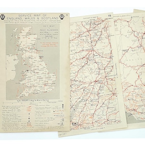 May include: A collection of vintage service maps of England, Wales, and Scotland. The maps, printed on aged paper, show detailed road networks in red. The title "Service Map of England, Wales & Scotland" is visible. The maps are arranged on a white background.