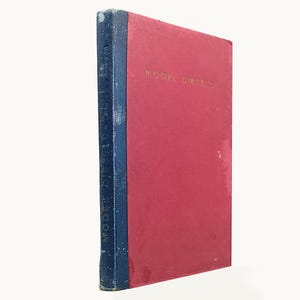 May include: A hardback book titled Model Diesels with a red front cover and a dark blue spine. The title is printed in gold lettering on the front cover and vertically along the spine. The book shows signs of wear on the spine and edges.