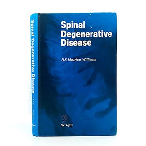 Op de afbeelding: Een hardcover boek met de titel "Spinal Degenerative Disease" van RS Maurice-Williams. De blauwe kaft heeft witte tekst en een grafisch ontwerp. De rug toont ook de titel en auteur.