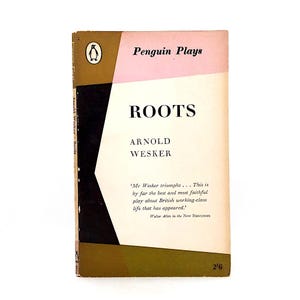 May include: A vintage paperback book titled "ROOTS" by Arnold Wesker. The cover features a geometric design in pink, black, and olive green, with the Penguin Books logo. The book is a play about British working-class life.