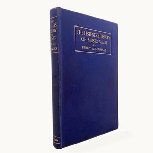 May include: A dark blue hardcover book titled The Listener's History of Music Vol. III by Percy A. Scholes. The front cover features a rectangular gold-bordered box containing the title and author name in gold lettering, with matching text on the spine.