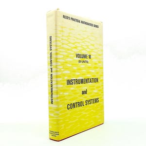 May include: A hardcover book titled Reed's Practical Mathematics Series Volume 10 (SI Units) Instrumentation and Control Systems. The cover is yellow with a white pattern of horizontal dashes and black text printed on the front and spine.