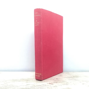 May include: A vintage hardcover book titled "The Talisman" by Sir Walter Scott. The book has a red cover with white lettering on the spine. The book is part of the Everyman's Library series.