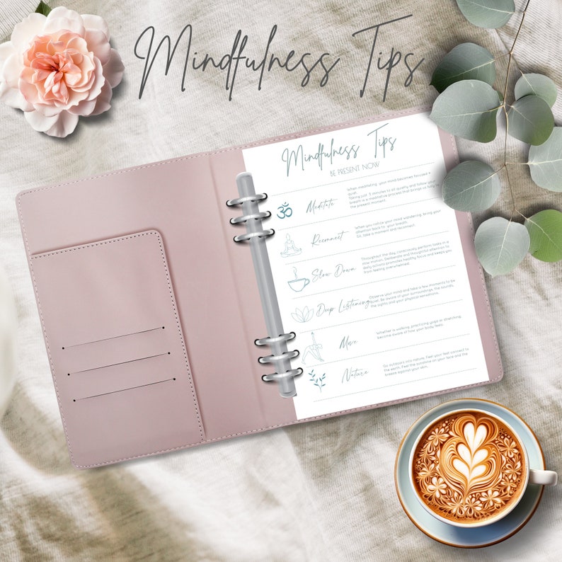 May include: A pink leather bound journal with a white page open to a list of mindfulness tips. The tips include meditation, movement, slowing down, deep listening, nature, and more. The journal has a silver ring binder.