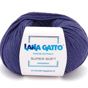 May include: A ball of deep purple yarn wrapped in a white paper label. The label features the blue text LANA GATTO, the words MADE IN ITALY, and the text SUPER SOFT. The website address www.lanagatto.it is printed in blue at the bottom of the label.