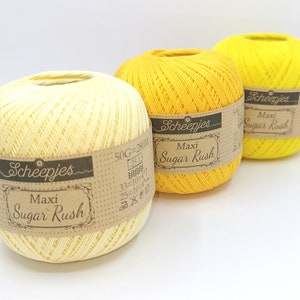 May include: Three balls of yarn in yellow and light yellow colors. The yarn is labeled 'Scheepjes Maxi Sugar Rush'.