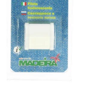 May include: A white spool of glow-in-the-dark thread, packaged in a blue and white card with the word "Halloween" at the top. The packaging includes text in multiple languages, including English, and the brand name "Madera".