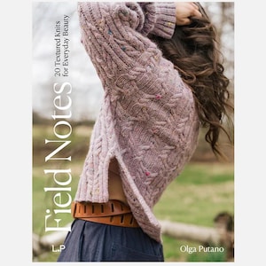 May include: A person wearing a mauve textured knit sweater with a side split. The sweater has flecks of colour. The book cover in the image reads "Field Notes 20 Textured Knits for Everyday Beauty" by Olga Putano.