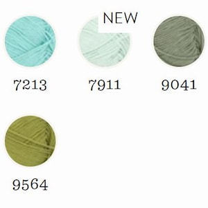 May include: A selection of yarn balls in various colors, including navy blue, teal, mint green, olive green, and pale yellow. Each ball is displayed in a circle with a corresponding number. The word "NEW" is above one of the yarn balls.
