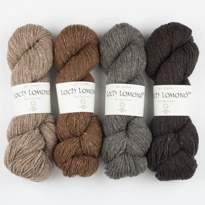 May include: Four skeins of yarn in different shades of brown, beige, and gray. The yarn is labeled "Loch Lomond 100% Organic Wool" and "BC Garn".