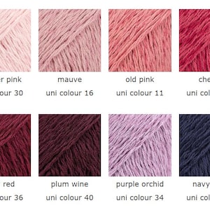 May include: A color palette of eight yarn samples in various shades of pink, red, and blue. Each sample is labeled with a color name and a "uni colour" number. Colors include powder pink, mauve, old pink, cherry, ruby red, plum wine, purple orchid, and navy blue.