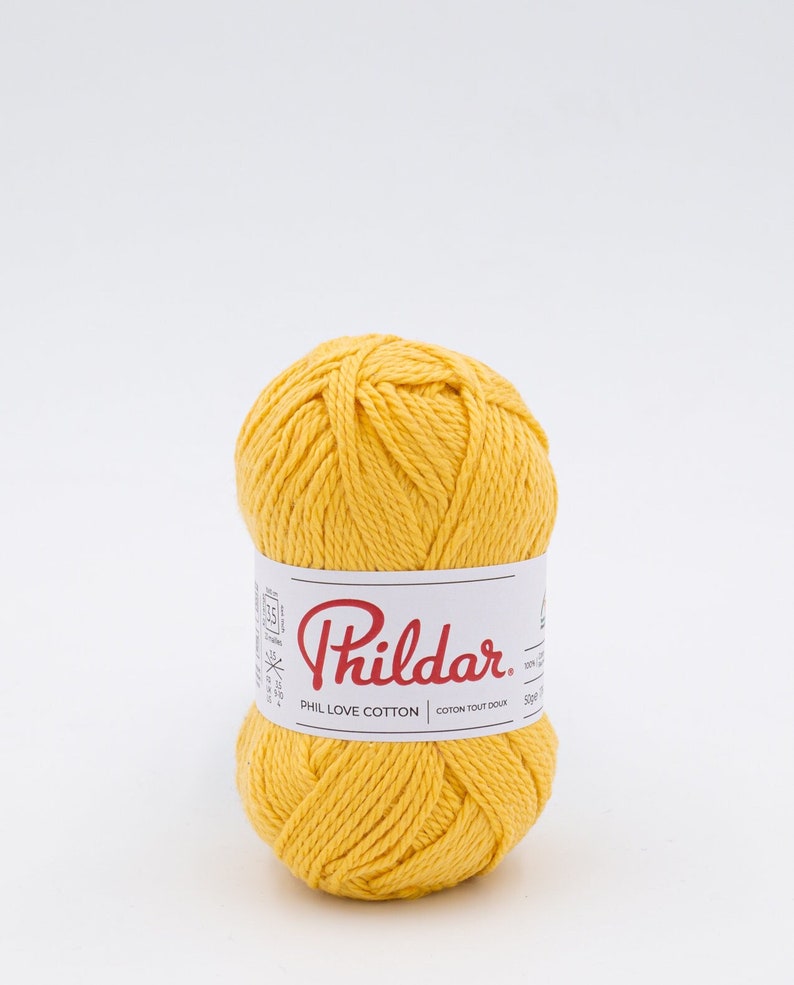 May include: A ball of yellow Phil Love Cotton yarn. The label reads 'Phildar' and 'Phil Love Cotton' in red text and 'Coton Tout Doux' in black text.