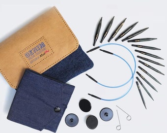 May include: A set of interchangeable circular knitting needles in a denim-themed case. The set includes a variety of needle sizes, as well as a set of cable cords and end caps. The case is made of a brown leather-like material with a blue denim lining. The case also includes a smaller pouch for storing the needles and cords.