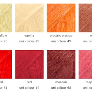 May include: A color palette of eight yarn samples, each in a different shade. Colors include misty yellow, vanilla, electric orange, rust, hot red, red, maroon, and raspberry. Each sample has the color name and uni color number displayed.