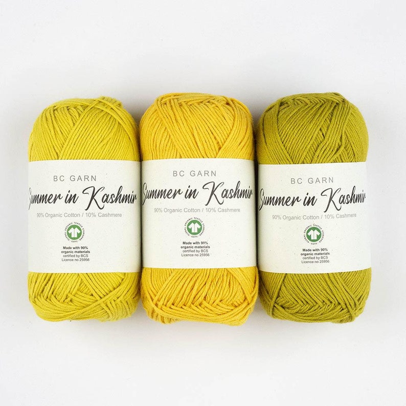 May include: Three skeins of yarn, one yellow, one yellow, and one green. The yarn is labeled 'BC Garn Summer in Kashmir 90% Organic Cotton/10% Cashmere' and 'Made with 90% organic materials certified by BCS Licence no 25056'.