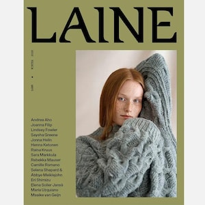 May include: The cover of "LAINE" magazine features a woman with red hair wearing a gray cable-knit sweater. The magazine title is in large, black letters. The cover has a green background with the text "WINTER 2026" and a list of names.