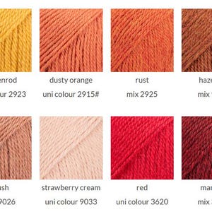 May include: A grid of eight yarn color samples featuring goldenrod, dusty orange, rust, hazelnut, blush, strawberry cream, red, and maroon. Each square displays the color name and specific product code, such as uni colour 2923 or mix 9025.