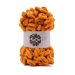 Puede incluir: Una bola de hilo Pingo Cool naranja, un hilo suave y grueso perfecto para tejer o hacer crochet. El hilo está empaquetado en una etiqueta blanca con el logotipo de Pingo Ouin y el texto "Pingo Cool Soft Touch Yarn".