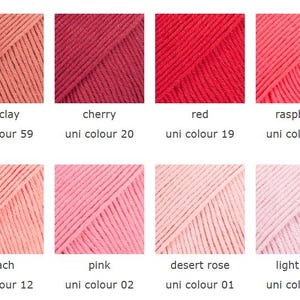 May include: A color palette of eight yarn samples in shades of red, pink, and peach. Each sample is labeled with a color name and a uni color number. Colors include red clay, cherry, red, raspberry, peach, pink, desert rose, and light rose.