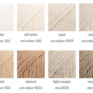 May include: A grid of eight yarn samples in neutral shades. The colors are labeled as white 101, off white 100, sand 9039, wheat 9036, camel 302, almond 9031, light nougat 2020, and nougat 618, displaying various textures and tones of beige.