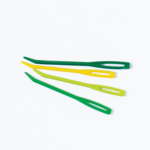 May include: Four plastic crochet hooks in green and yellow. The hooks are arranged in a fan shape.