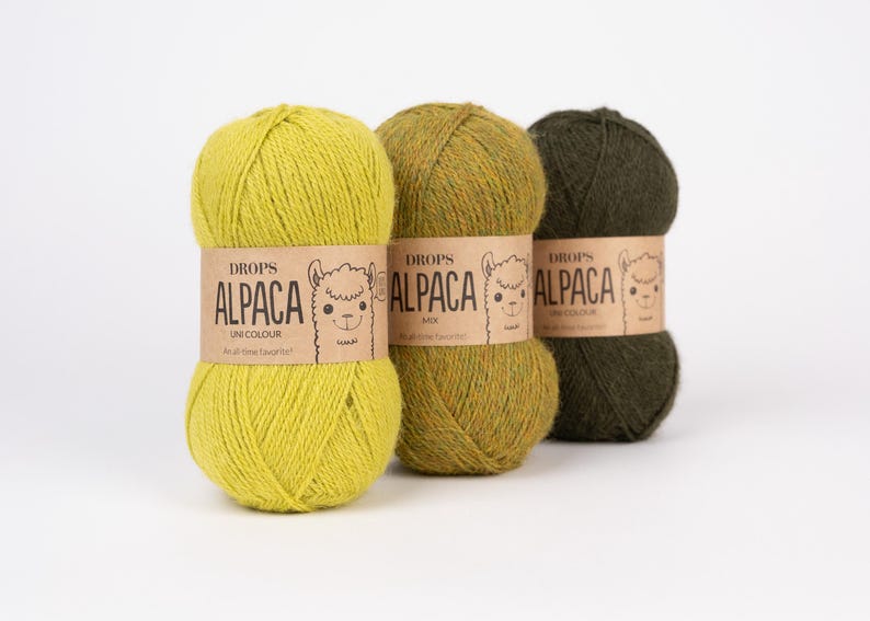 May include: Three skeins of yarn arranged in a row, featuring a bright lime green, a mottled olive green, and a dark forest green. Each skein is wrapped in a tan paper band labeled DROPS ALPACA with a line drawing of an alpaca face.