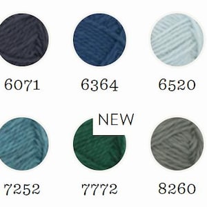 May include: A color chart featuring ten circular yarn samples in shades of blue, teal, green, and gray. Each sample is labeled with a numerical code: 6052, 6071, 6364, 6520, 6573, 6937, 7252, 7772, 8260, and 8264. The sample labeled 7772 includes a white tag with the text NEW.