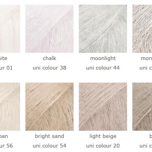 May include: A collection of eight skeins of yarn in various neutral colors. The colors include off-white, chalk, moonlight, morning fog, marzipan, bright sand, light beige, and beige. Each skein is labeled with its color name and a corresponding uni color number.