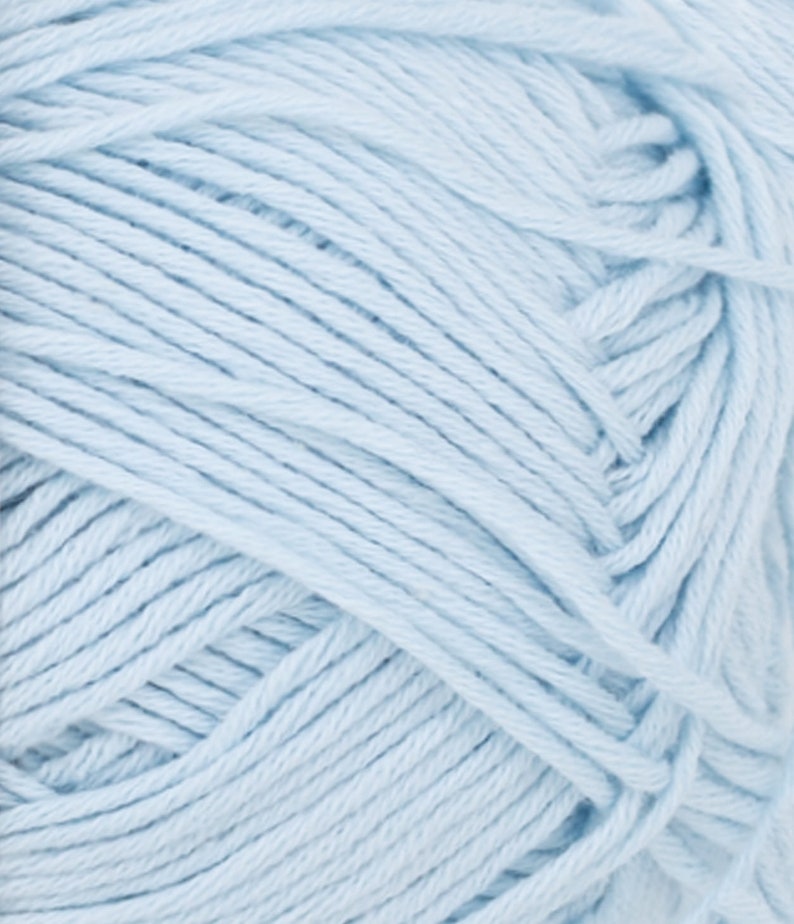 May include: Close-up of a ball of light blue yarn. The yarn is tightly wound, showing individual strands with a textured appearance. The color is a soft, pastel blue, suitable for knitting or crocheting projects.