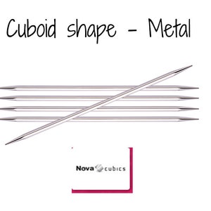May include: Five silver metal knitting needles in a cuboid shape. The needles are arranged in a criss-cross pattern. The text "Nova cubics" is visible in the lower right corner of the image.