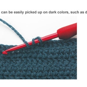Puede incluir: Primer plano de un gancho de crochet rojo con un lazo de hilo azul, que muestra c&oacute;mo recoger puntos en una tela oscura.