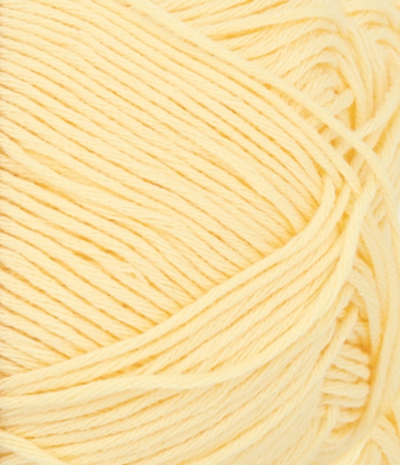 May include: Close-up of a skein of pale yellow yarn. The yarn is tightly wound, showing individual strands. The color is a soft, creamy yellow, ideal for knitting or crocheting projects. The texture appears soft and inviting.