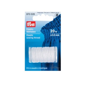 May include: A white spool of elastic sewing thread on a blue and white packaging card. The card says "Elastic sewing thread" and "20 m Ø 0.5 mm".