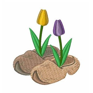 May include: An embroidered design featuring two wooden clogs with a yellow and a purple tulip growing out of them. The clogs are a light brown color, and the tulips have green stems and leaves.