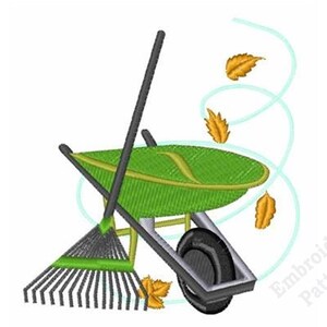 May include: An embroidery design featuring a green wheelbarrow and a black rake positioned together. Three golden-yellow autumn leaves are depicted falling in a swirling motion, with the text Embroidery Patterns visible in the lower right corner.
