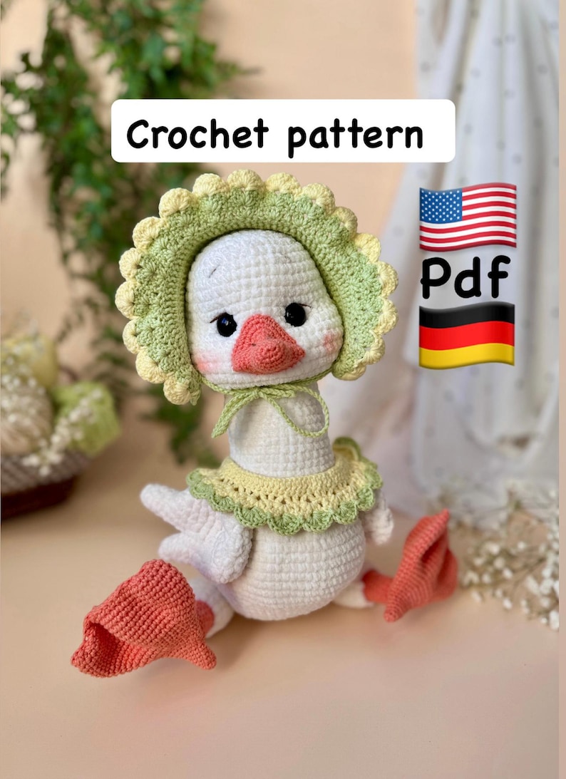 May include: A handmade crochet goose doll with a white body, a pink beak, and black eyes. The goose wears a green and yellow bonnet and collar. The image includes the text "Crochet pattern" and a PDF symbol with the American and German flags.