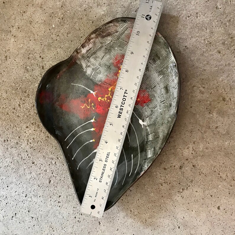 ceramic fruit dish artsy in black clay with modern painting in red white and yellow