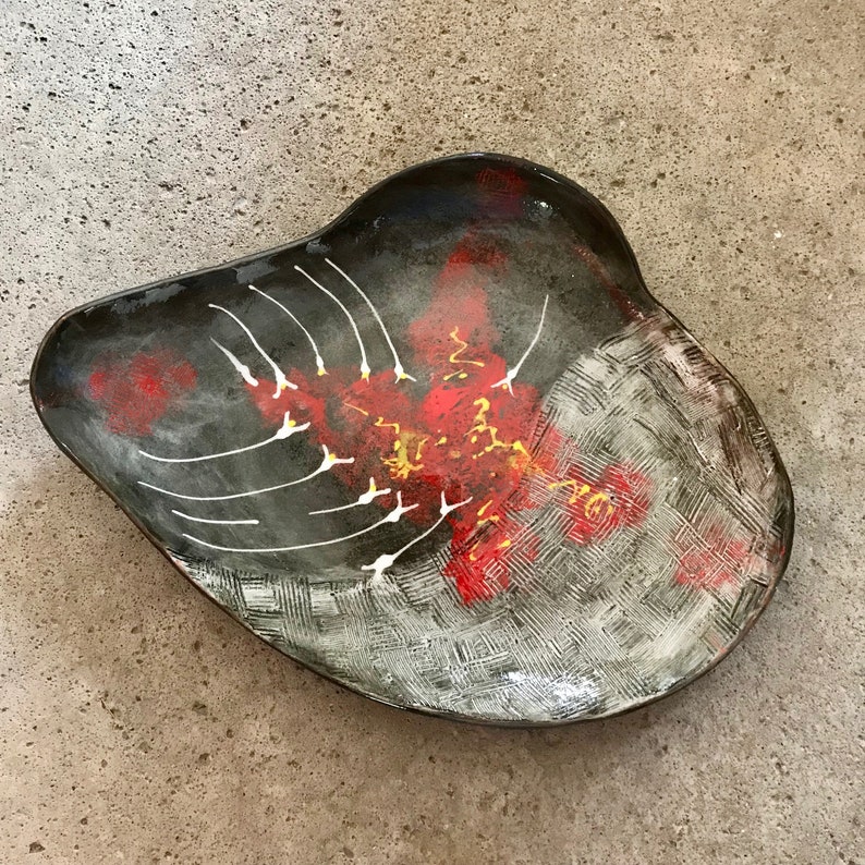 ceramic fruit dish artsy in black clay with modern painting in red white and yellow