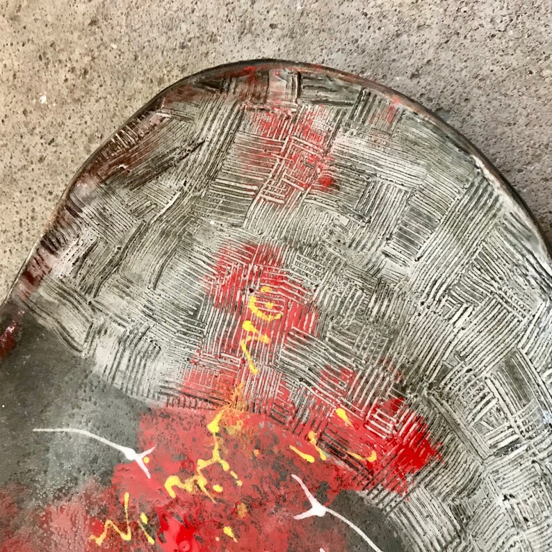 ceramic fruit dish artsy in black clay with modern painting in red white and yellow