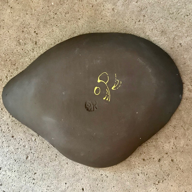 ceramic fruit dish artsy in black clay with modern painting in red white and yellow