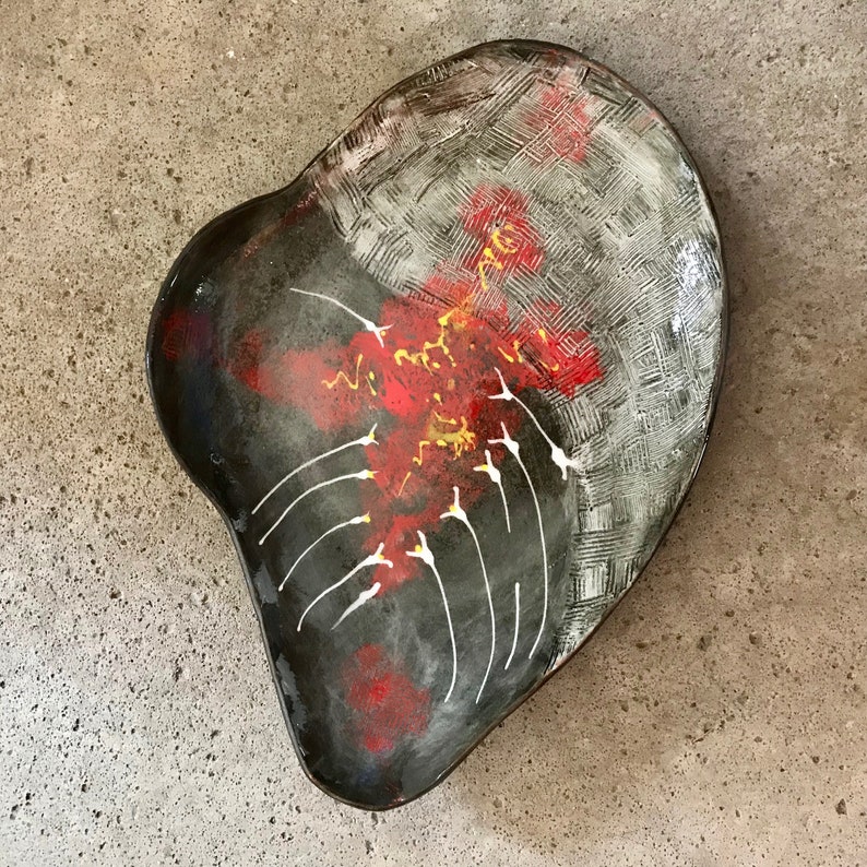 ceramic fruit dish artsy in black clay with modern painting in red white and yellow