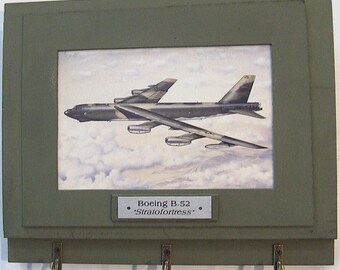 Wall Mounted Keychain Rack with a print of a painting of a Boeing B-52 Stratofortress Bomber over the sands of Iraq during Desert Storm.