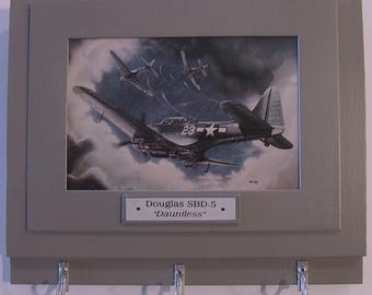 Wall Mounted Keychain Rack with a print of a painting of a Douglas "Dauntless" diver bomber preparing to strike.