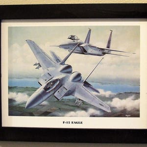 This 14 1/2&quot; X 18 1/2&quot; Black Framed Print Painting ( 12&quot; X 16&quot; image size) is of two F-15 Eagles in hot pursuit of their prey!