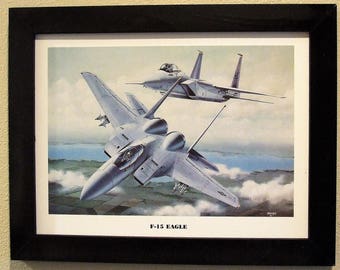 This 14 1/2" X 18 1/2" Black Framed Print Painting ( 12" X 16" image size) is of two F-15 Eagles in hot pursuit of their prey!