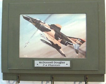Wall Mounted Keychain Rack with a print of a painting of a McDonnell Douglas F-4 Phantom II shooting down a MiG over Vietnam.