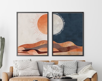 May include: Two framed abstract art prints with a desert landscape theme. The print on the left features a sun with rays and the print on the right features a moon. Both prints have a muted colour palette of orange, brown, and blue.
