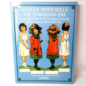 May include: A book cover featuring antique paper dolls from the Edwardian era. The cover shows four dolls in full color, dressed in period clothing. The title of the book is "Antique Paper Dolls: The Edwardian Era".