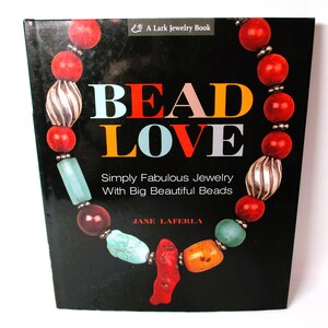May include: Book cover with the title "BEAD LOVE" in colorful letters. The subtitle is "Simply Fabulous Jewelry With Big Beautiful Beads". The author is Jane Laferla. The cover features a colorful beaded necklace.